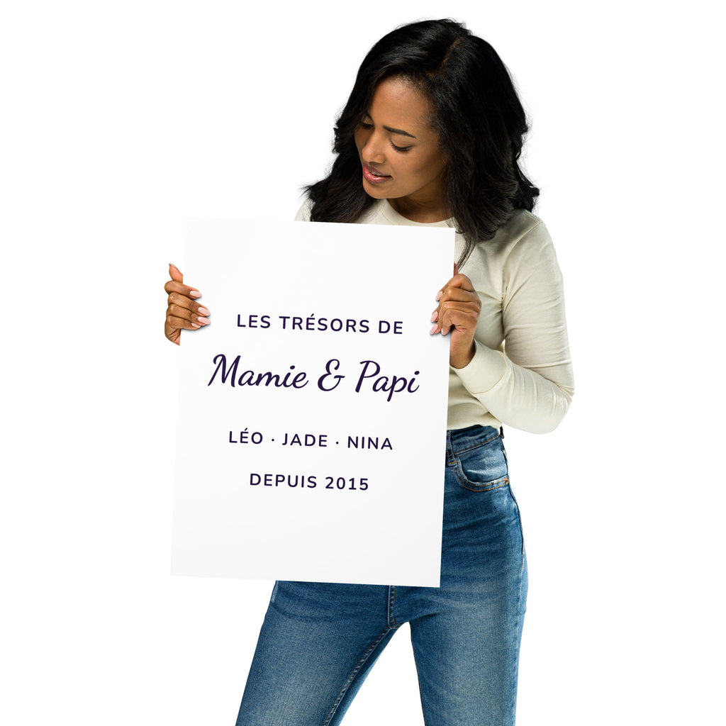 Femme tenant l'affiche personnalisée « Mamie & Papi » avec les prénoms des petits-enfants